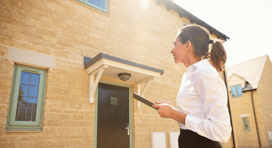 woman with clip board outside of home with a domestic claim