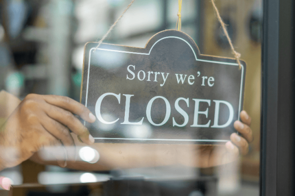 Business closed - store sign saying "Sorry we're closed"