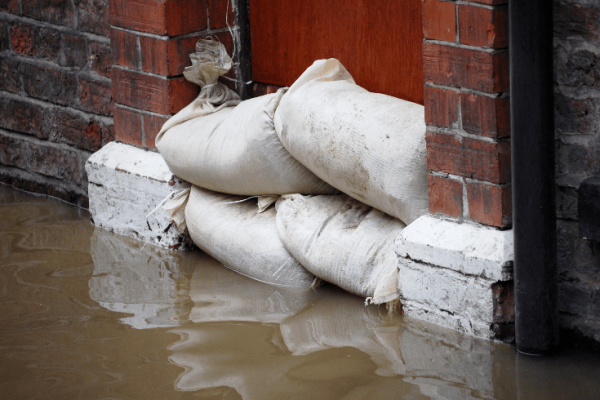 Flooding with sand bags in front of door.